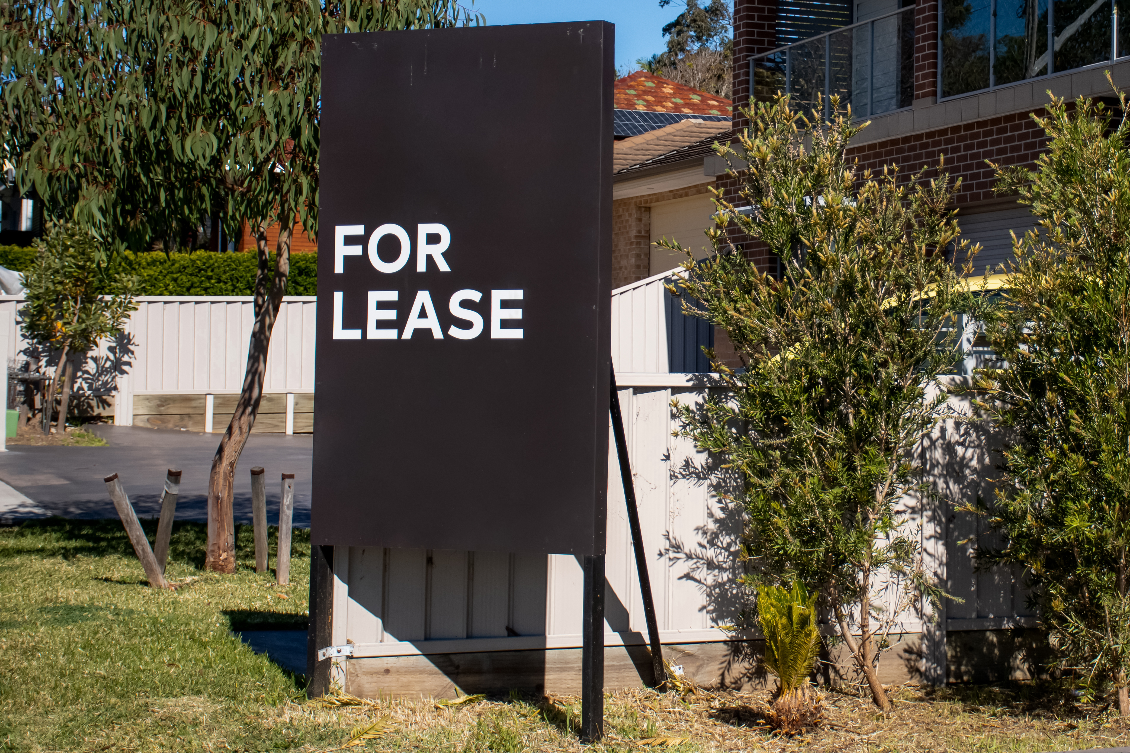  For lease sign on a black display outside of a resedential building in Australia. 