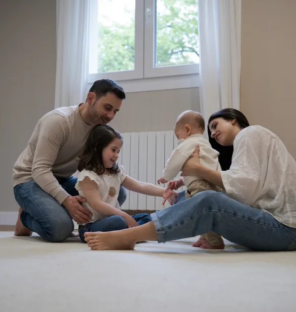 Happy family playing together on the floor at home
