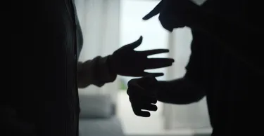 Close-up hands of unhappy couple fighting and yelling in the living room.
