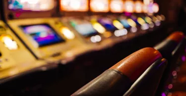 Blurry image of pokies machines inside a casino.