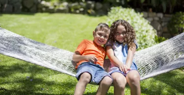 First Nations' Australian children playing in hammock