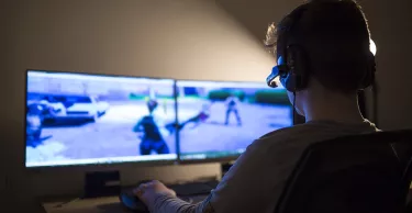 Young boy playing games on a computer at home