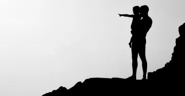Silhouette of man carrying child