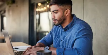 Worker, thinking or typing on laptop in cafe, coffee shop or restaurant on startup ideas, vision or web design ux. 