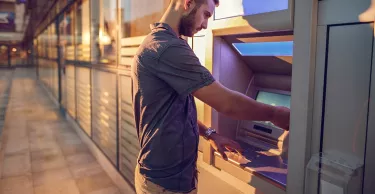 Businessman withdrawing cash from a bank's ATM