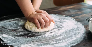 Close up stock photo of a woman kneading dough
