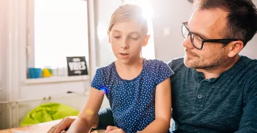 Father and daughter using tablet