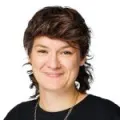 Person with mullet smiling 