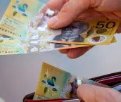 Hands holding wallet with Australian dollars and make a payment - Coronavirus finance struggle concept