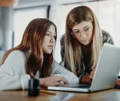 Mother and child doing homeschooling, e-learning at home because of the corona virus pandemic covid-19 quarantine