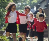 A group of school children running in the school yard as they head to playtime. Two of the children are siblings and go to the same school in Hexham in the North East of England. A group of school children running in the school yard as they head to playtime. Two of the children are siblings and go to the same school in Hexham in the North East of England.