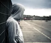 Lonely hooded man in a desolate urban environment Lonely hooded man in a desolate urban environment