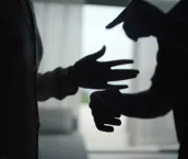 Close-up hands of unhappy couple fighting and yelling in the living room.