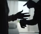 Close-up hands of unhappy couple fighting and yelling in the living room. Close-up hands of unhappy couple fighting and yelling in the living room.