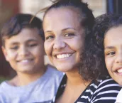 Aboriginal Family portrait with 1 parent and 2 children.