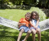 First Nations' Australian children playing in hammock