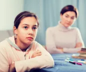 Mother talking seriously with her teenage daughter about poor school performance Mother talking seriously with her teenage daughter about poor school performance