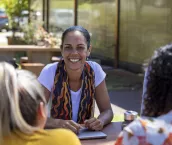Close-up of young aboriginal students studying together outdoors in the sun in Australia.
