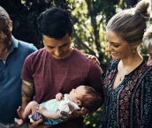 Shot of a young couple introducing their newborn baby son to his grandparents