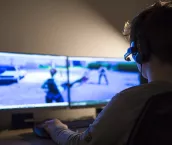 Young boy playing games on a computer at home