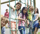 Portrait Of School Pupils Playing On Climbing Frame Portrait Of School Pupils Playing On Climbing Frame