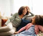 Mother and daughter having fun in the living room