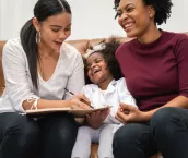 LGBT diversity Lesbian Couple Moments Happiness with her african girl laughing and drawing picture, LGBT lifestyle.