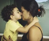 Mother and son embracing.