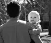 Father carrying his toddler child Father carrying his toddler child