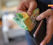 Closeup of hands taking money out of a wallet