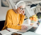 Woman using laptop and wearing headphones Woman using laptop and wearing headphones
