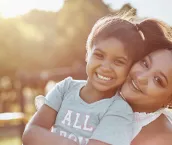 Portrait of a mother bonding with her daughter outdoors