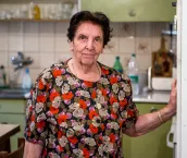 Smiling Senior Woman Looking Out Of Window