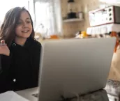 Girl studying and making a video call via laptop at home