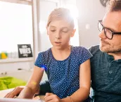 Father and daughter using tablet