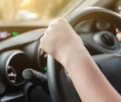 Woman driving her car with both hands on steering wheel Woman driving her car with both hands on steering wheel