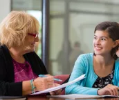 Preteen girl meeting with school counselor or therapist