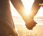Upclose rearview shot of a young couple holding hands at the beach Upclose rearview shot of a young couple holding hands at the beach