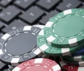 Casino gambling chips on computer keyboard.