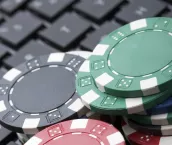 Casino gambling chips on computer keyboard. Casino gambling chips on computer keyboard.