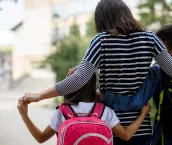 Mother taking kids to school