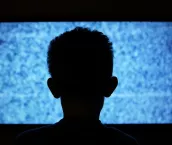 Boy in front of TV screen