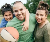 Family of three playing basketball