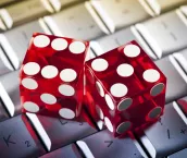 Two red clear dice sitting on a keyboard