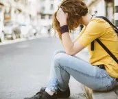 Depressed girl sitting on ground