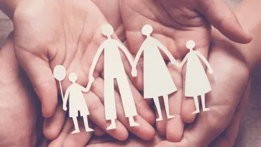 Adult and children hands holding paper family cutout, family home, adoption, foster care, homeless support, family mental health, autism support, domestic violence concept.