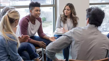 As the therapy group members listen, the teen boy shares his life experiences. As the therapy group members listen, the teen boy shares his life experiences.