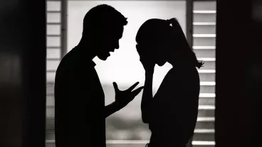 Silhouette of a man and woman having an argument at home. Silhouette of a man and woman having an argument at home.