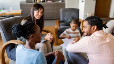 Family at home with mental health professional, discussing their problems