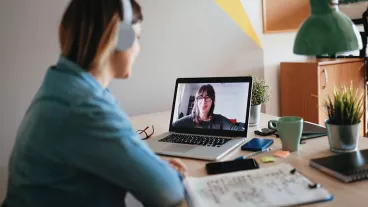 Young woman teleconferencing with sister on laptop on conference call Young woman teleconferencing with sister on laptop on conference call